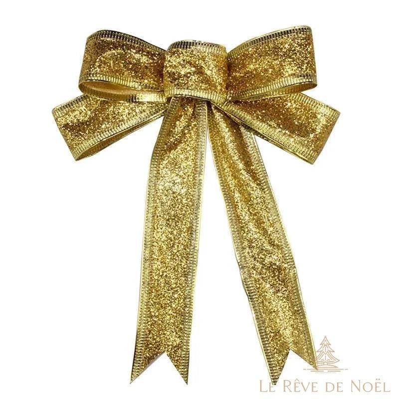 Nœud tout fait en ruban pailleté doré, boucles multiples et pans effilés sur fond blanc