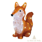 Renard en acrylique translucide ambré et blanc, assis, illuminé de LED, sur fond blanc