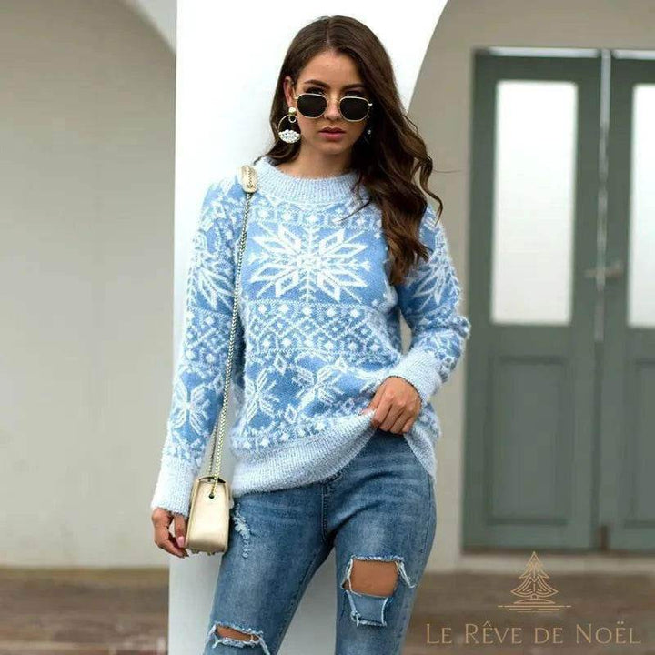 Pull bleu ciel à gros motif de flocon de neige blanc, porté avec un jean déchiré