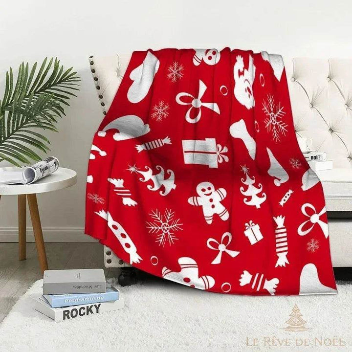 Plaid de Noël rouge à icônes blanches variées : nœuds, cadeaux, mitaines, flocons