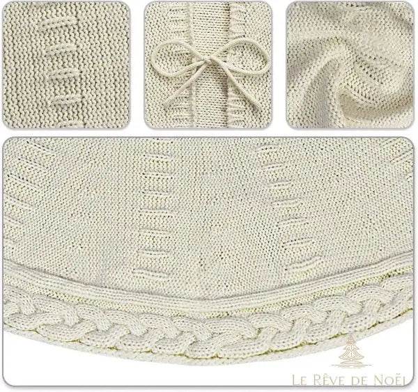 Gros plan sur le tricot écru : maille à jours, nœud du lien et bordure torsadée