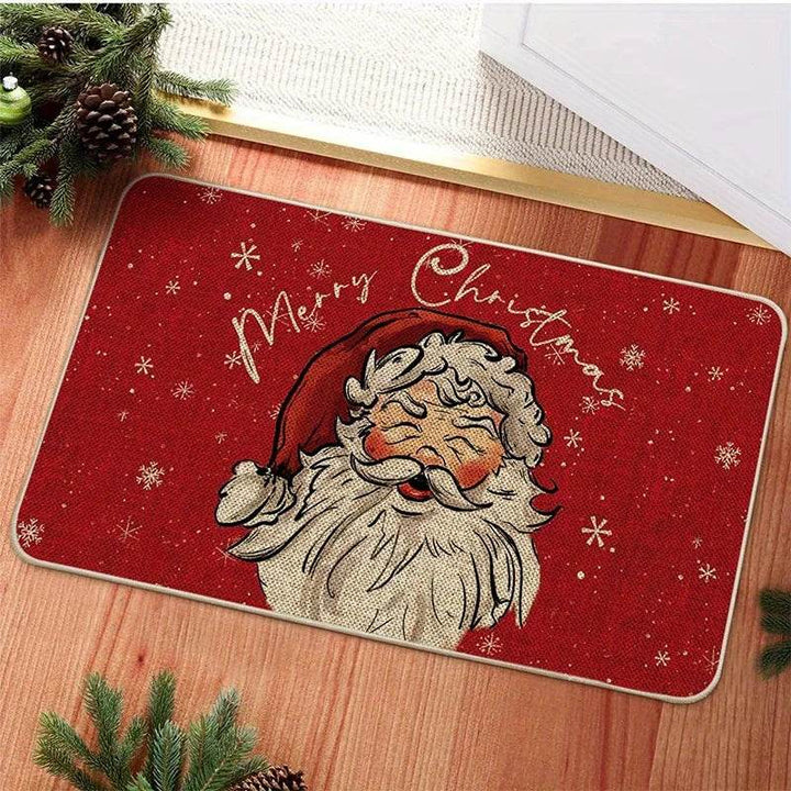 Tapis d'entrée rouge avec visage de Père Noël dessiné et texte doré Merry Christmas