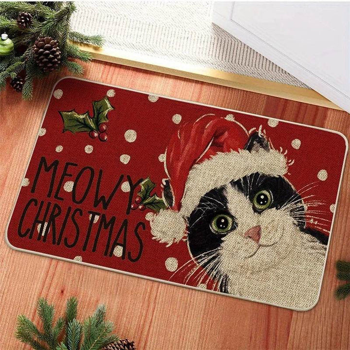 Tapis d'entrée rouge à pois, chat noir et blanc coiffé d'un bonnet de Père Noël, texte Meowy Christmas