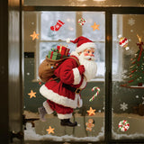 Stickers Père Noël et flocons sur une porte vitrée le soir, sapin illuminé visible à l'intérieur