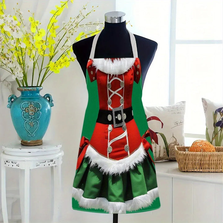Tablier de Mère Noël rouge et vert sur buste de mannequin, dans un intérieur décoré