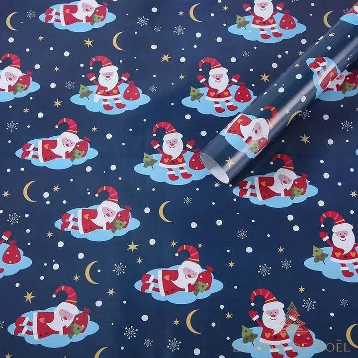 Rouleau de papier cadeau bleu marine, motif répété de Père Noël sur un nuage, lunes et étoiles dorées