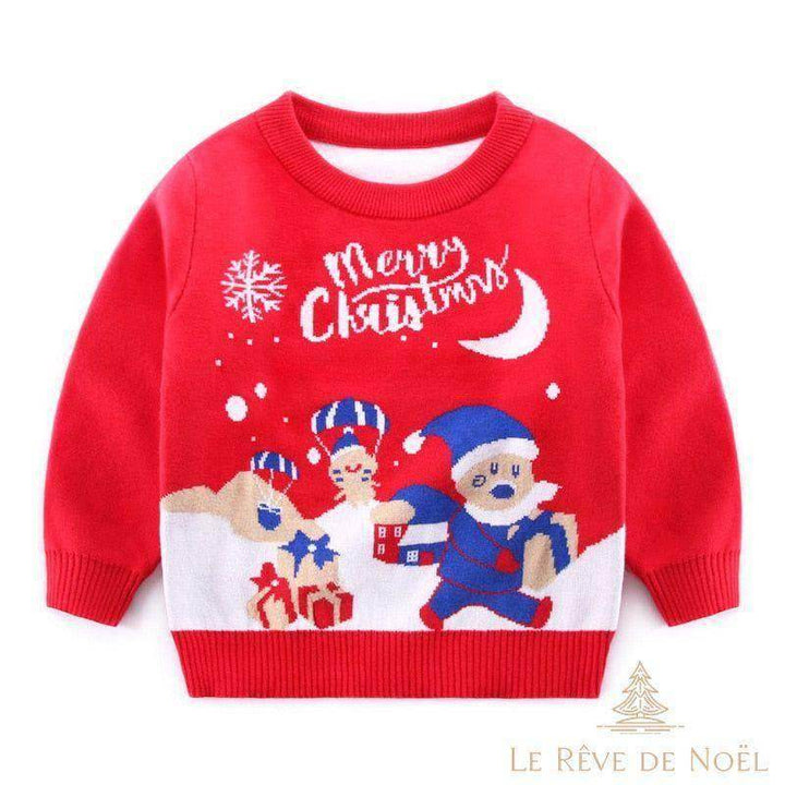Pull enfant rouge avec Père Noël en bleu, cadeaux et flocon tricotés sur fond blanc