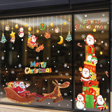 Sticker vitrine : Père Noël grimpé sur une haute pile de cadeaux, bonhomme de neige à ses côtés