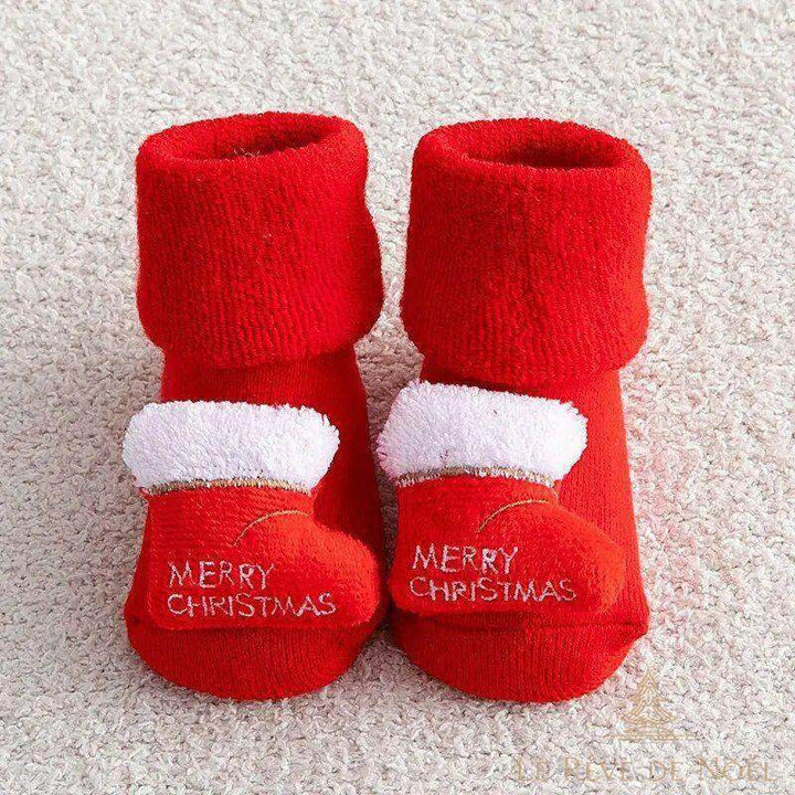 Paire de chaussettes de Noël bébé rouges, mini botte à bord blanc pelucheux sur le talon