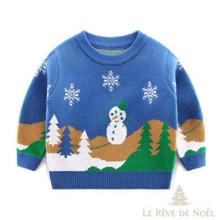 Pull de Noël enfant bleu à bonhomme de neige, sapins et flocons brodés, présenté à plat