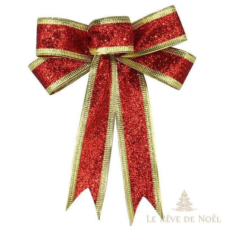 Nœud tout fait en ruban pailleté rouge à liseré doré, boucles et pans effilés sur fond blanc