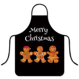 Tablier noir « Merry Christmas » avec trois biscuits en pain d'épices, famille souriante