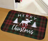 Tapis à carreaux vert et rouge avec silhouette blanche de renne entre deux sapins