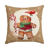 Housse de coussin beige illustrée d'un bonhomme pain d'épice en bonnet de Père Noël et sucre d'orge