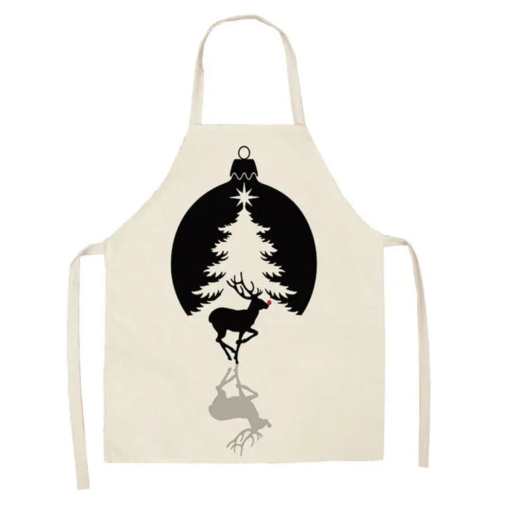Tablier de Noël blanc, boule noire encadrant un sapin clair, renne noir au nez rouge et son ombre