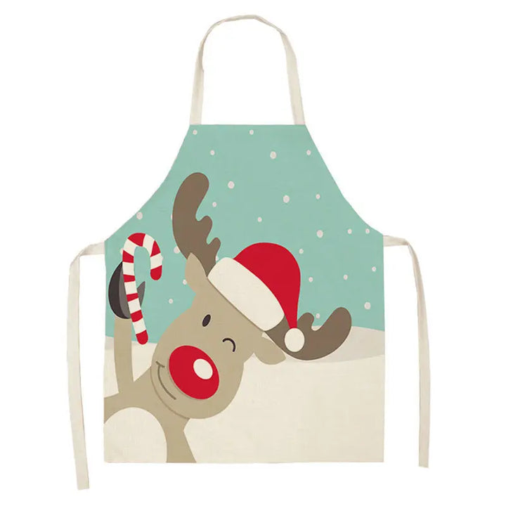 Tablier de Noël à grosse tête de renne inclinée, bonnet rouge et sucre d'orge, fond vert menthe