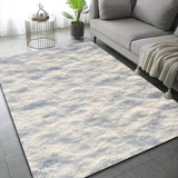 Tapis effet neige, variante Neige 3, teinte beige tachetée de gris, près d'un canapé clair