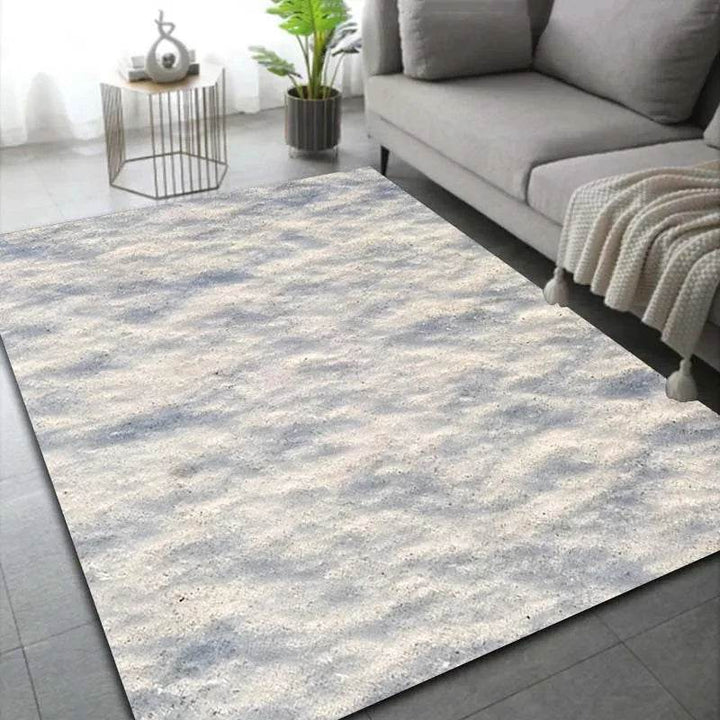Tapis effet neige, variante Neige 3, teinte beige tachetée de gris, près d'un canapé clair