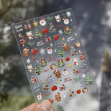 Planche de stickers ongles avec visages de Père Noël, oursons, pommes et couronnes