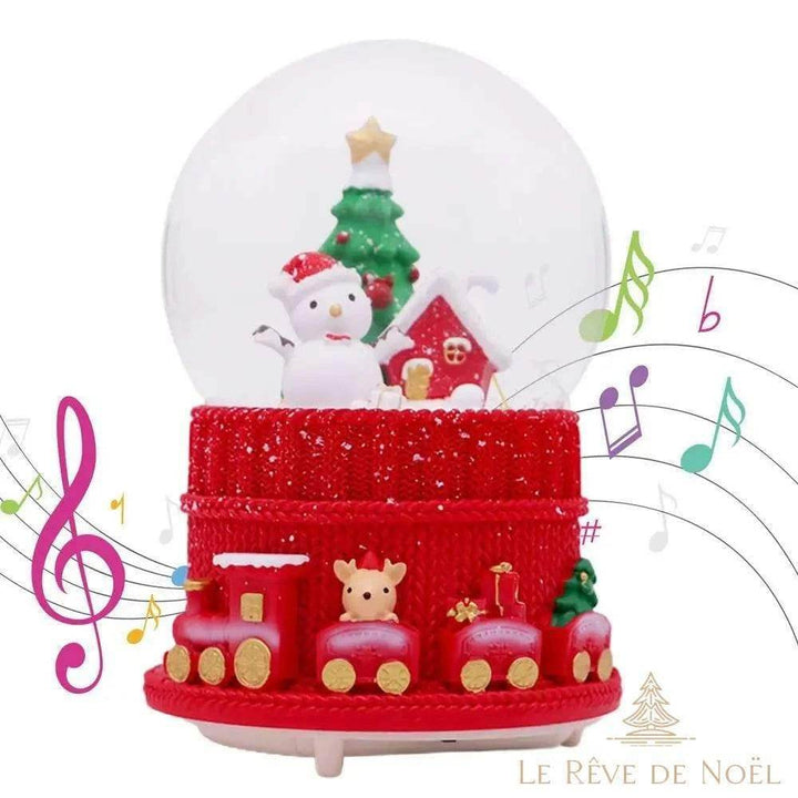 Boule à neige musicale de Noël, bonhomme de neige sous le globe, socle rouge façon train, notes illustrées