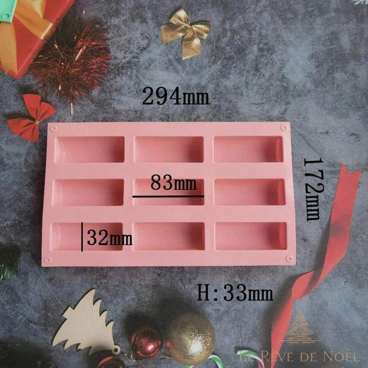 Schéma coté du moule à bûche rose : 294 x 172 mm, empreintes 83 x 32 mm, hauteur 33 mm