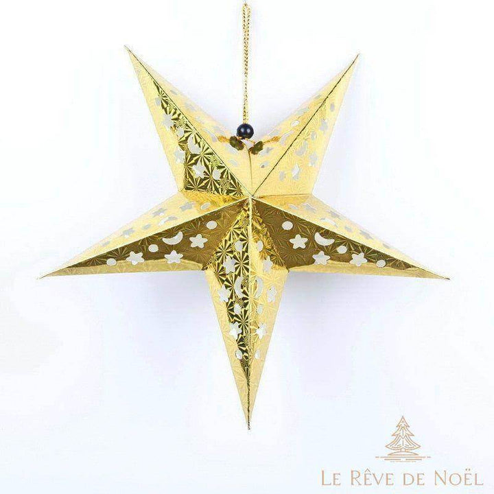 Étoile de Noël en papier doré 30 cm, motifs étoiles et lunes ajourés, suspendue sur fond blanc