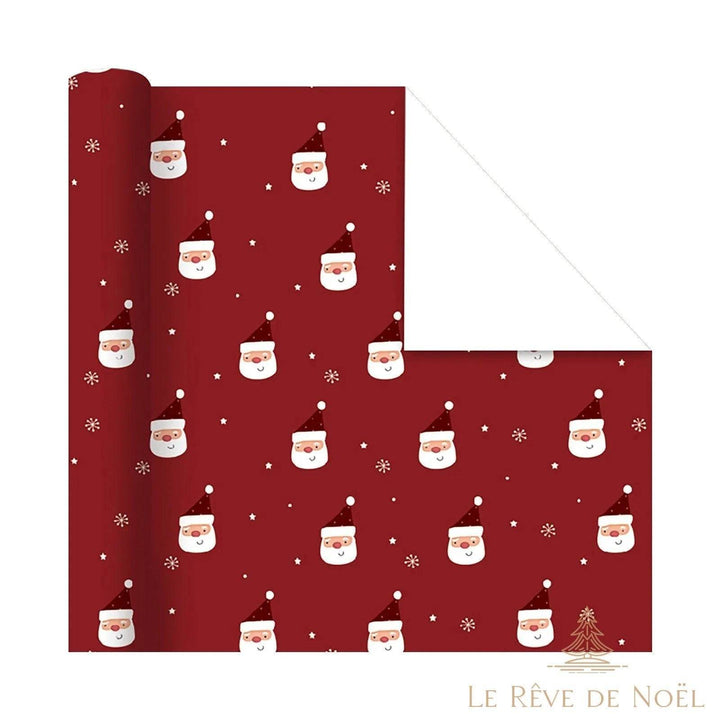 Rouleau de papier cadeau rouge foncé à petits visages de Père Noël, étoiles et flocons, envers blanc
