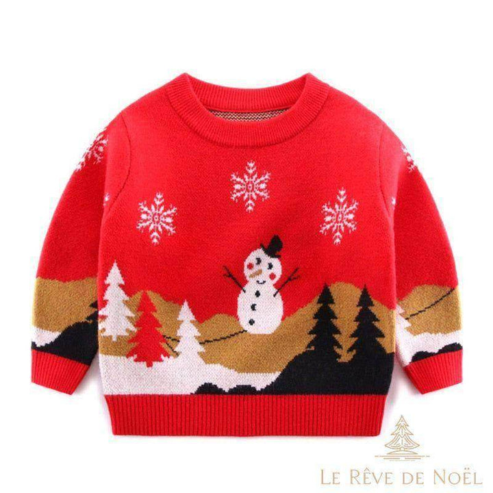 Pull de Noël enfant rouge à bonhomme de neige, sapins et flocons brodés, présenté à plat