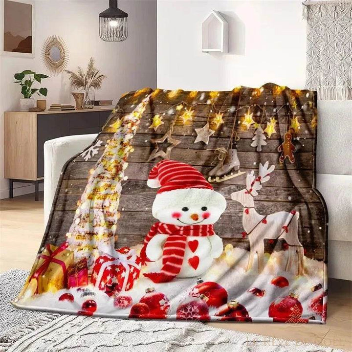 Plaid de Noël à fond bois, bonhomme de neige, renne et guirlande lumineuse, posé sur un fauteuil