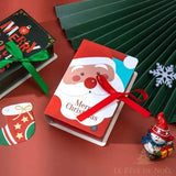 Boîte cadeau rouge illustrée d'un visage de Père Noël, nouée d'un ruban rouge