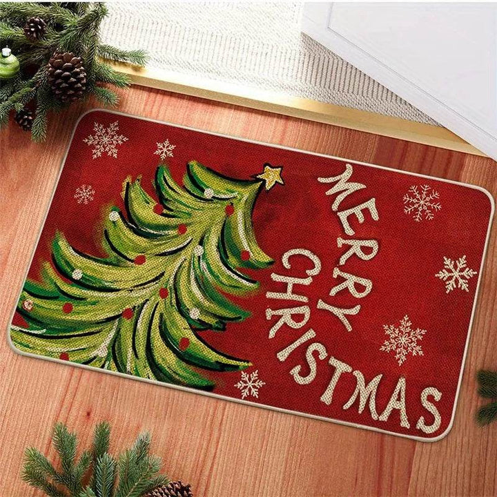 Tapis d'entrée rouge avec sapin peint et texte Merry Christmas, posé devant une porte