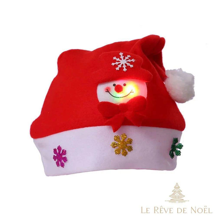 Bonnet de Noël rouge et blanc, visage de bonhomme de neige lumineux et nœud rouge en gros plan