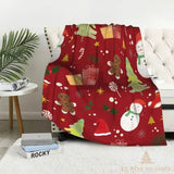 Plaid de Noël rouge à illustrations peintes : bonhomme de neige, sapins et cadeaux