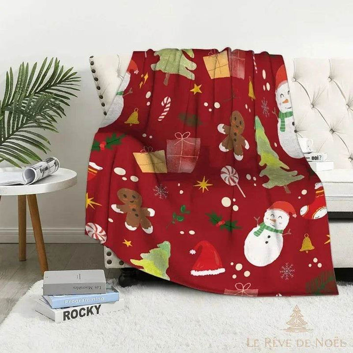 Plaid de Noël rouge à illustrations peintes : bonhomme de neige, sapins et cadeaux