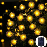 Guirlande lumineuse à épis blancs solaire déployée sur une haie, panneau solaire visible en médaillon