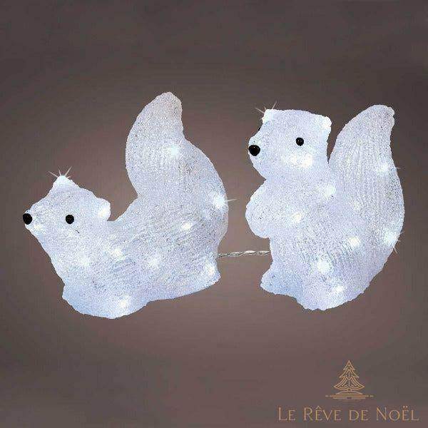Deux écureuils en acrylique blanc à LED intégrées, assis face à face, sur fond uni