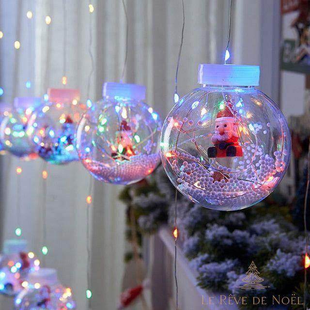 Rideau de boules lumineuses multicolores avec une figurine de Père Noël miniature à l'intérieur