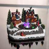 Même village lumineux de Noël photographié sur une surface brillante qui reflète le décor