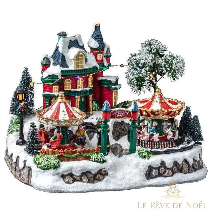 Village de Noël miniature illuminé avec manèges et maison enneigée
