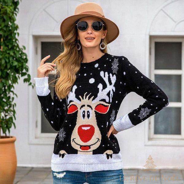 Femme portant un pull de Noël noir à motif de renne souriant, chapeau beige et lunettes de soleil