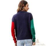 Pull moche de Noël vu de dos : dos uni bleu marine, manches colorblock rouge et verte