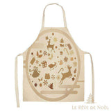 Tablier de cuisine beige avec motifs de Noël (rennes, traîneau, sapins) en cercle, vu de face