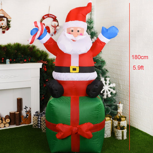Structure de Noël gonflable : Père Noël assis sur un cadeau