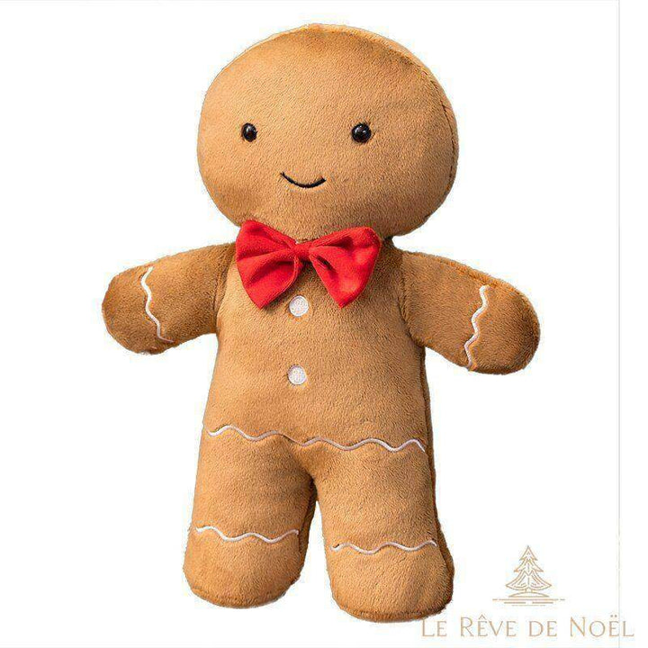 Peluche bonhomme en pain d'épices debout, bras ouverts, nœud papillon rouge, fond blanc uni