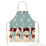 Tablier de cuisine bleu clair avec une rangée de bonhommes de neige souriants et des flocons