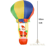 Père Noël gonflable dans une montgolfière multicolore, bras levés, hauteur 180 cm, fond blanc