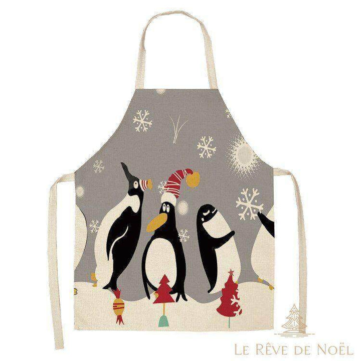 Tablier de cuisine gris avec trois pingouins illustrés, l'un coiffé d'un bonnet de Noël rouge