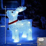 Renne acrylique lumineux blanc et bleu dans la neige, collier rouge, modèle sur prise