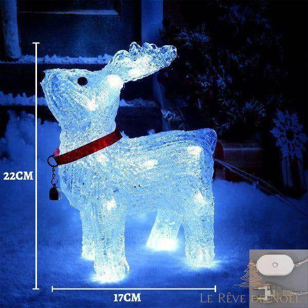 Renne acrylique lumineux blanc et bleu dans la neige, collier rouge, modèle sur prise