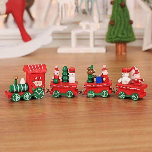 Petit train de Noël en bois rouge à roues vertes, wagons avec Père Noël et bonhomme de neige
